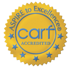 CARF Gold Seal that reads Aspire to Excellence. CARF Accredited.  